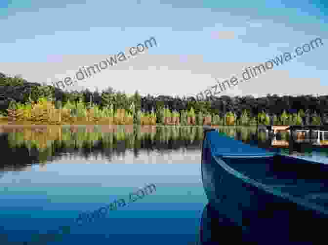 A Lone Canoe Paddling Through A Secluded Wilderness Lake, Surrounded By Tranquil Waters And Towering Mountains Inheriting A Canoe Paddle: The Canoe In Discourses Of English Canadian Nationalism (Cultural Spaces)