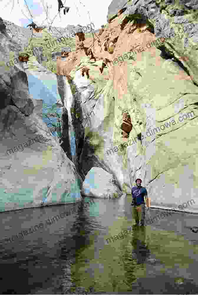 Hikers Ascend The Trail Through Tahquitz Canyon, Surrounded By Majestic Rock Formations And Lush Vegetation. Day Hiking Trails Of Palm Springs And The Coachella Valley