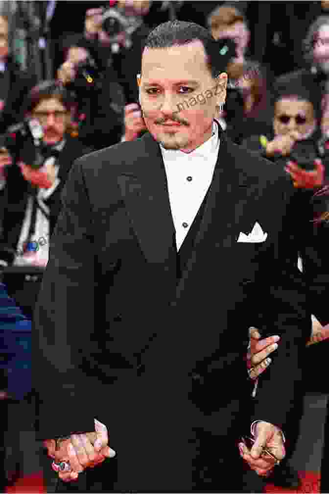 Johnny Depp Standing On A Red Carpet, Smiling And Waving Johnny Depp (People In The News)