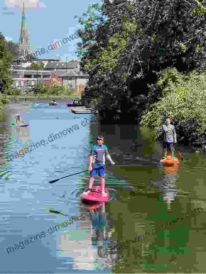 Paddleboarding On An English Canal, Surrounded By Idyllic Countryside And Historic Bridges Stand Up Paddleboarding In Great Britain: Beautiful Places To Paddleboard In England Scotland Wales